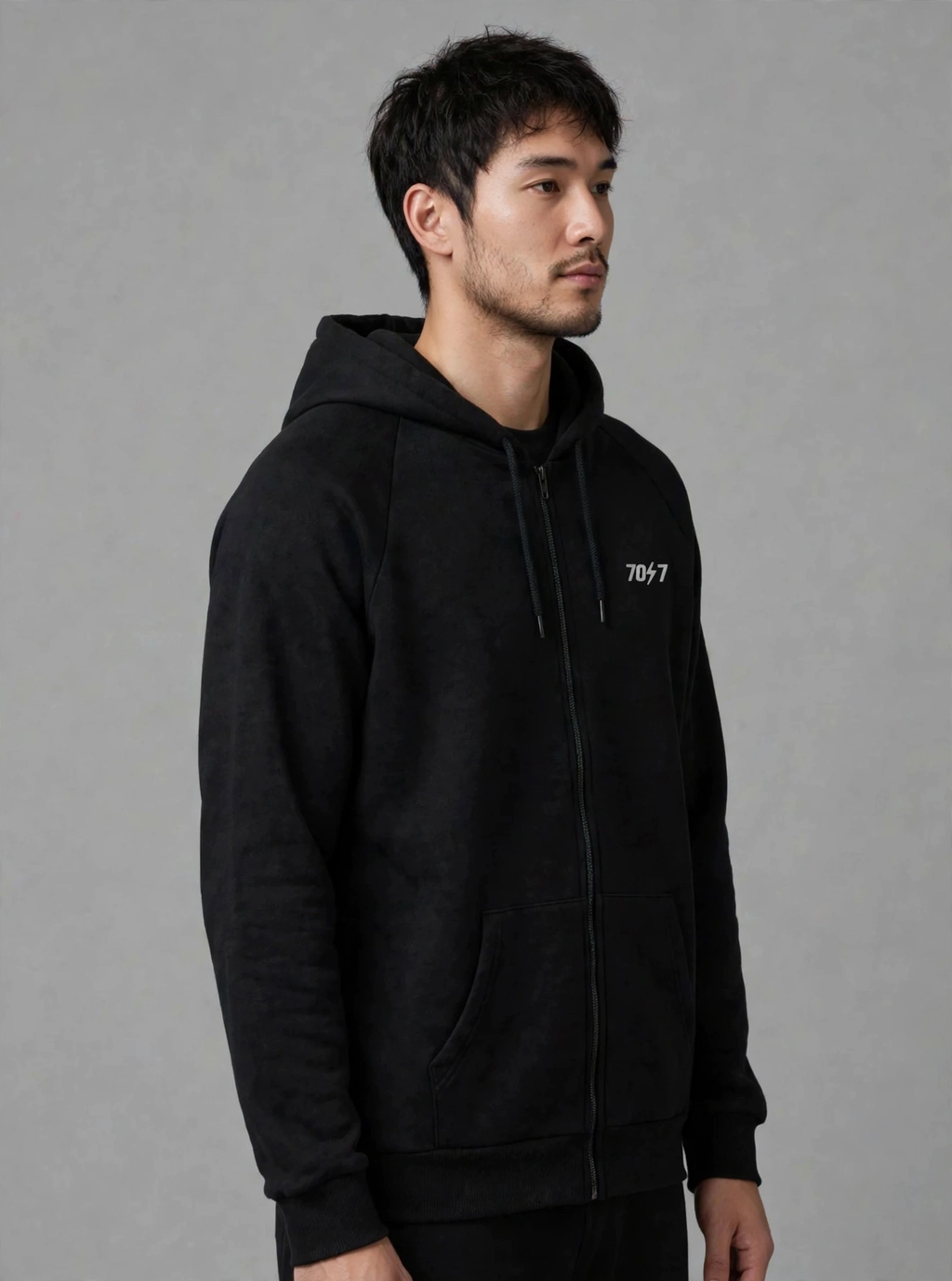 The Collective Black Hoodie — black on model, three-quarter view | 707 Official zip hoodie