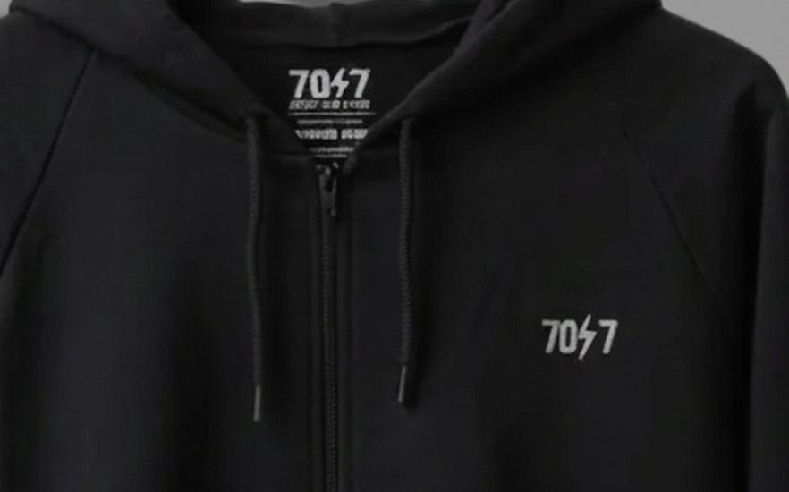 The Collective Black Hoodie — black collar and 70ϟ7 chest logo close-up | 707 Official zip hoodie