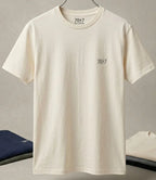 Beige t-shirt with '7047' branding on a gray background