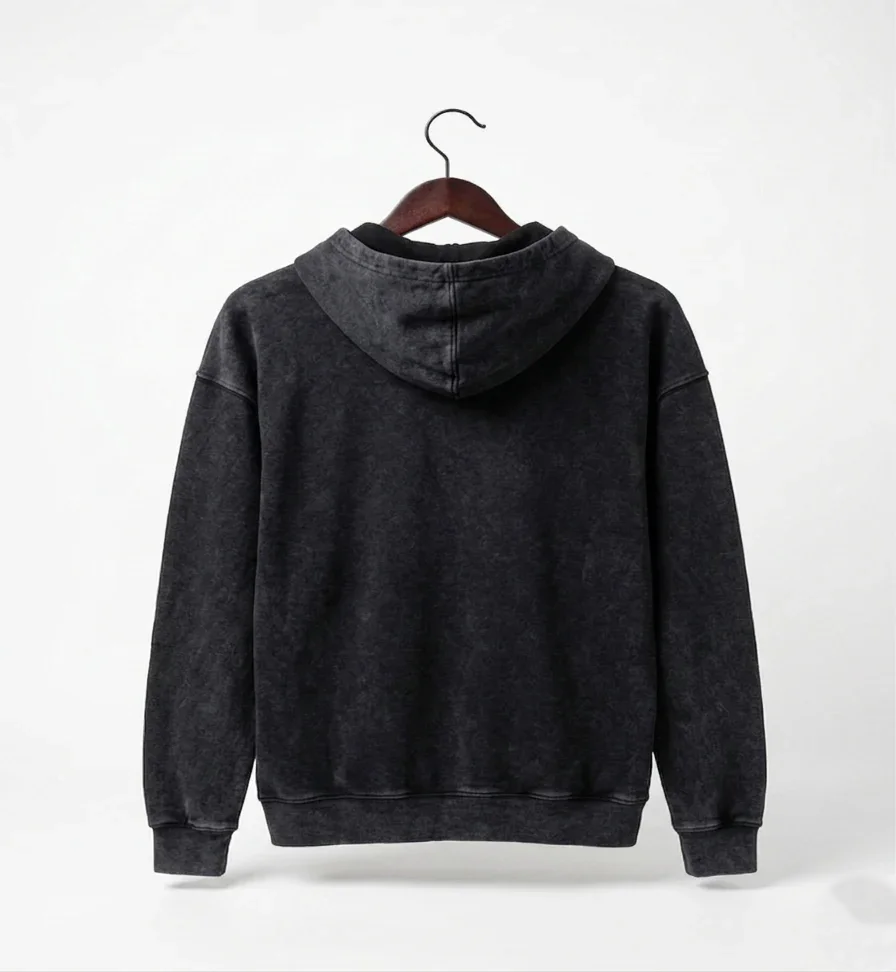 Black hoodie on a hanger against a white background