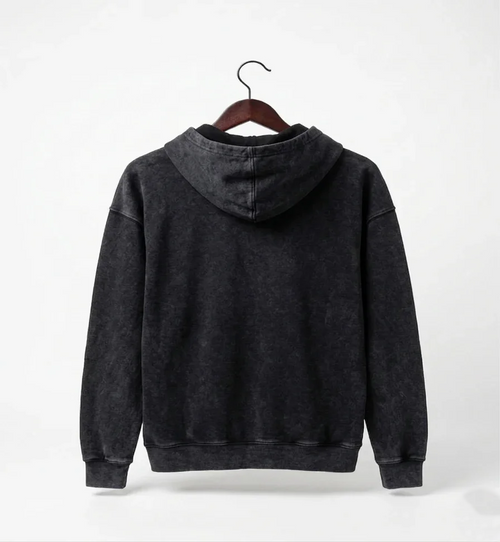 Black hoodie on a hanger against a white background