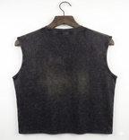 Black sleeveless vest on a wooden hanger against a white background
