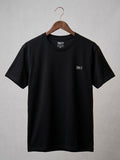 Black t-shirt with a logo on a hanger against a gray background