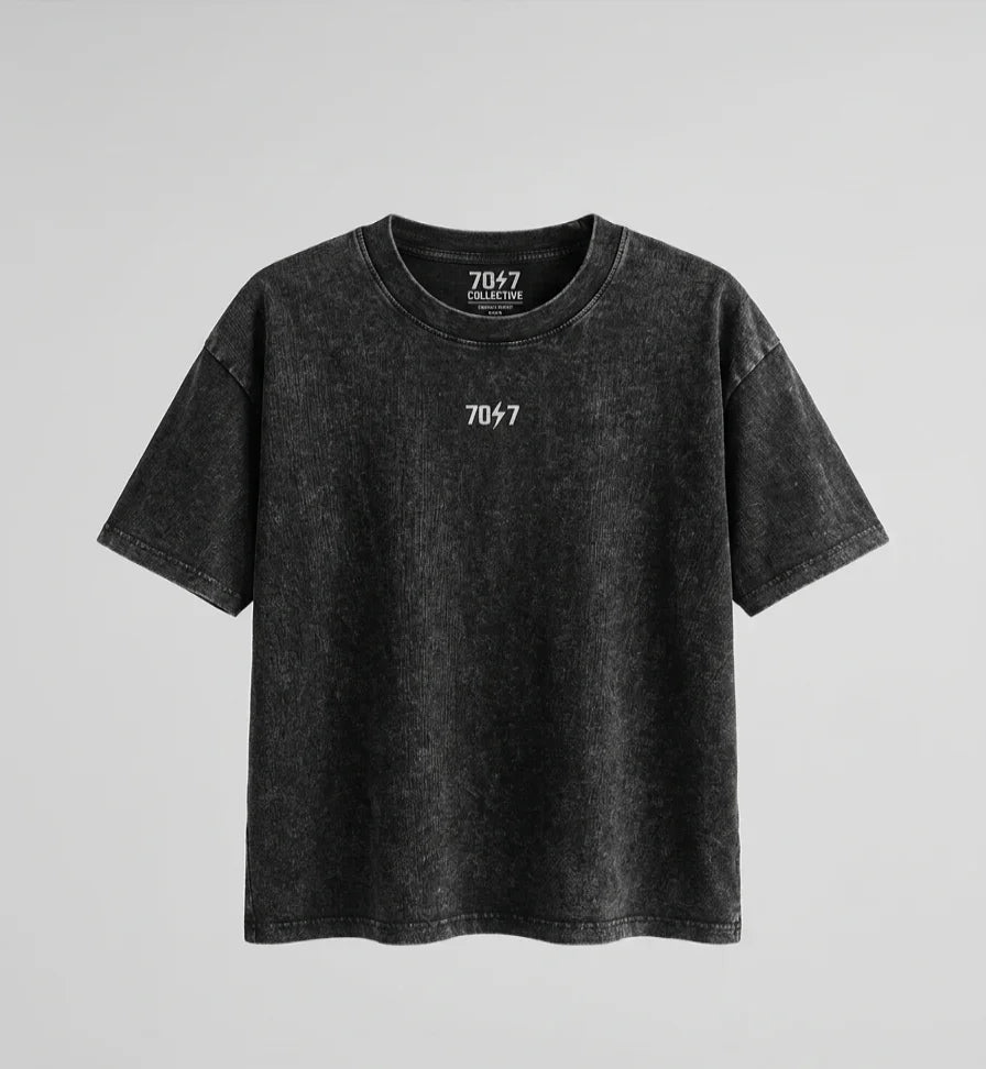 Black t-shirt with a logo on a gray background