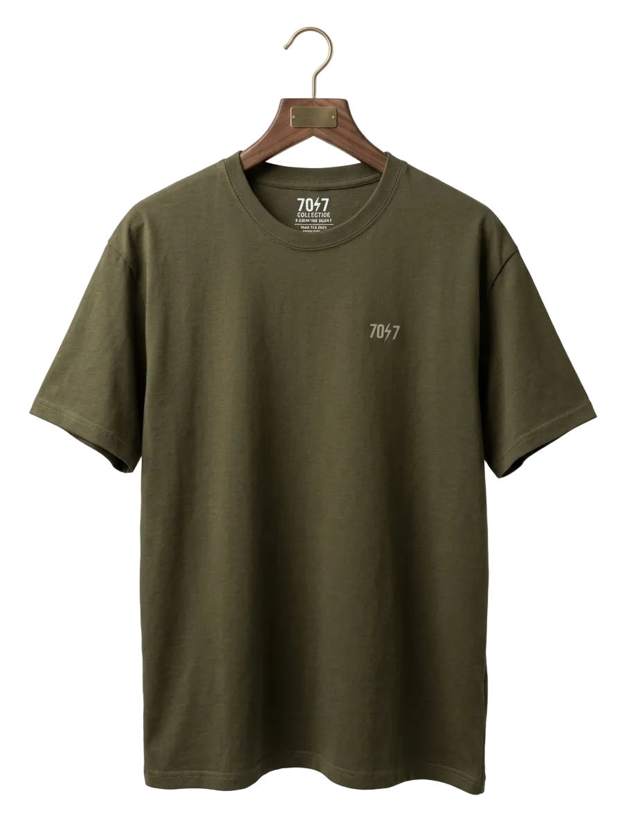 Green t-shirt with '7047' logo on a hanger against a white background