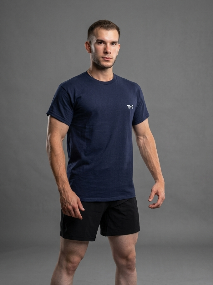 The Collective Core — navy on model, angled view | 707 Official tee