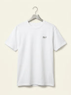 White t-shirt with a logo on a hanger against a beige background