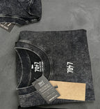 Folded t with brand logo on a gray surface